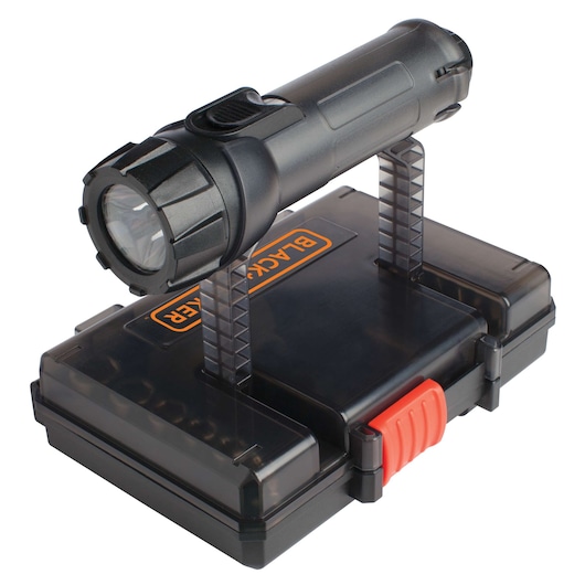 A BLACK+DECKER branded flashlight mounted on a transparent stand attached to a black plastic tool case with an orange latch.