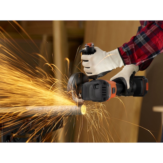 BLACKDECKER BCG6L8F1S cordless angle grinder in use cutting metal pipe, bright sparks flying, close-up action.