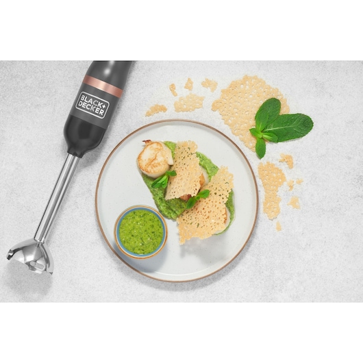 Photo of BLACK+DECKER BCKM1016KSG hand blender with scallops, green sauce, and crispy cheese garnish on a white plate.