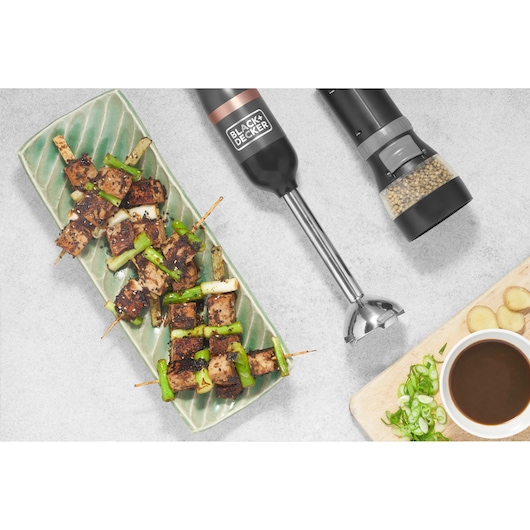 Photo of BLACK+DECKER hand blender BCKM1011KGF with food and spice grinder on kitchen counter.