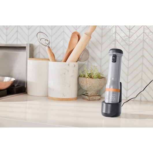 BLACKDECKER BCKM1011KGF immersion blender on kitchen countertop, upright in charging base.