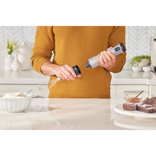 BLACKDECKER BCKM1012KG hand mixer being assembled in a kitchen, close-up front angle.