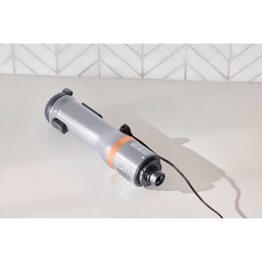 BLACKDECKER BCKM1012KG handheld electric tool, silver with black and orange accents, angled on countertop.