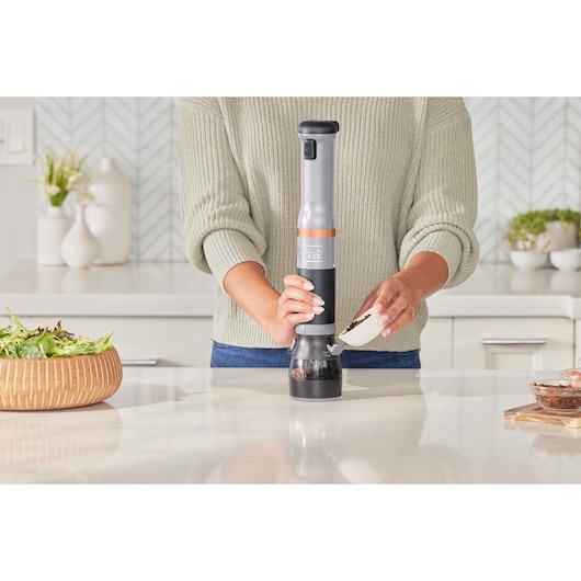 Photo of BLACKDECKER BCKM1016KSG electric spice grinder in use on a kitchen counter.