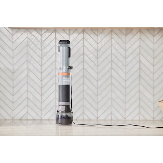 BLACKDECKER BCKM1016KSG upright cordless stick vacuum cleaner on countertop, front view.