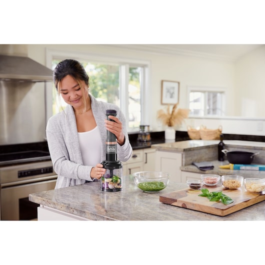 Photo of BLACKDECKER food processor BCKM101FP in use on kitchen counter, surrounded by ingredients.