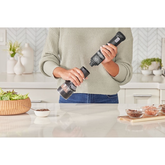 BLACKDECKER BCKM101SPFF electric spice grinder being used in a modern kitchen, photography front angle.