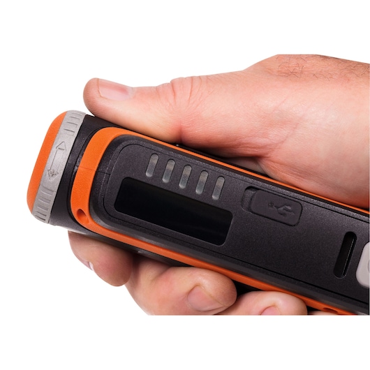 Close-up of BLACK+DECKER BCRT8IK portable tool with orange and black casing, LED indicators, and USB port in hand.
