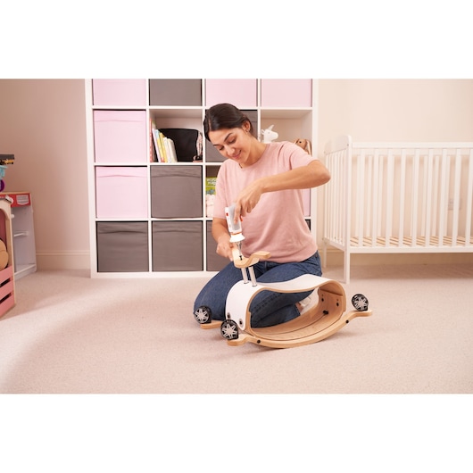 BLACKDECKER BCRTA01 cordless screwdriver used to assemble wooden toy vehicle in nursery setting.