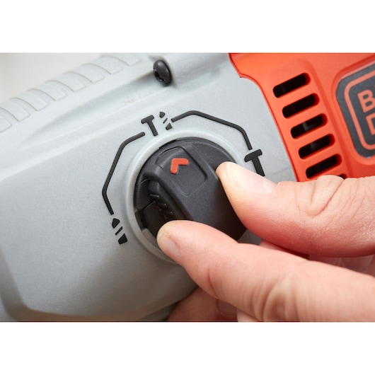 Close-up photo of BLACKDECKER BEHS02K power tool mode selector dial being turned by hand.
