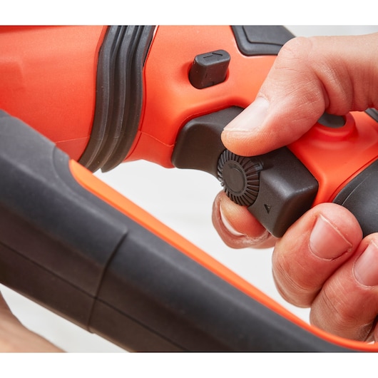 Close-up photo of BLACKDECKER BEHS02K tool handle with user adjusting black rotary switch, orange and black design.