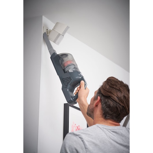 BLACKDECKER BHFEA520J cordless vacuum cleaner used for corner cleaning indoors.