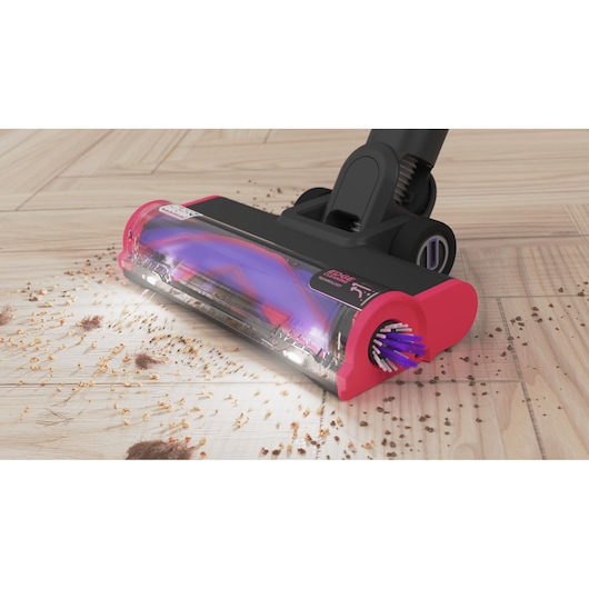 BLACKDECKER BHFEA640WG vacuum head close-up on hardwood floor picking up debris, pink and black design.
