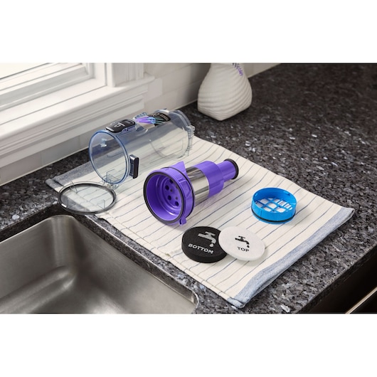 BLACKDECKER BHFEA640WP vacuum filter parts on towel, including dustbin, purple filter, and labeled discs.