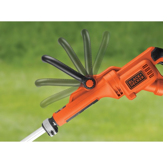 Photo of BLACK+DECKER GL9035 grass trimmer handle with adjustable black auxiliary handle, side angle, on green background.