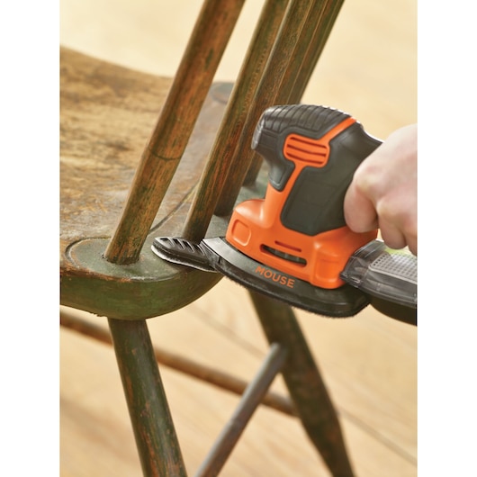 BLACKDECKER KA2000KA10 detail sander sanding an old green wooden chair close-up.