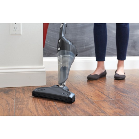 BLACKDECKER NSVA315J stick vacuum cleaner on hardwood floor, side angle view.