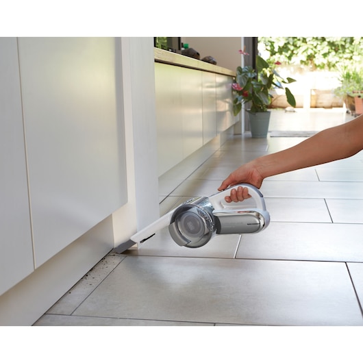 BLACKDECKER PV1820L handheld vacuum cleaning floor corner near cabinet
