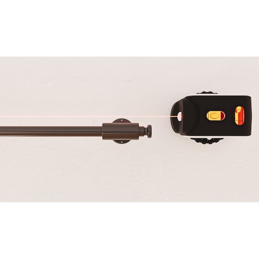 BLACKDECKER REVBDLL100 photography of black laser level tool mounted on white wall, front angle