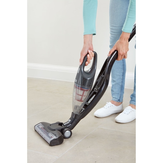 Photo of BLACKDECKER SVB620JW cordless stick vacuum on tile floor, person detaching handheld unit.