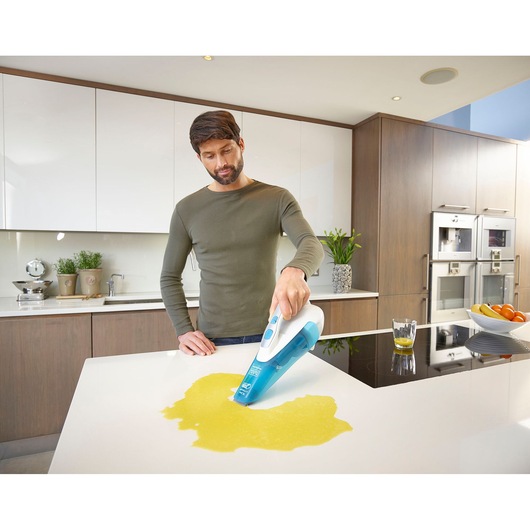 BLACKDECKER WDA315J handheld vacuum cleaning liquid spill on kitchen counter.